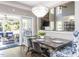 Elegant dining room with stylish chandelier, seating, and access to a sunroom with lots of natural light at 1201 Kalworth Rd, Wake Forest, NC 27587