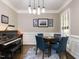 Formal dining room with piano, game table, and window views, accented by elegant trim at 1201 Kalworth Rd, Wake Forest, NC 27587