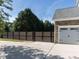 Driveway with view of garage with stone accents and privacy gate at 1201 Kalworth Rd, Wake Forest, NC 27587
