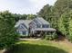 Inviting two-story home with a covered front porch, well-manicured lawn, and attractive landscaping at 1201 Kalworth Rd, Wake Forest, NC 27587