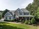 Charming two-story home with a covered front porch, stone accents, and meticulously maintained landscaping at 1201 Kalworth Rd, Wake Forest, NC 27587