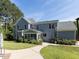 Rear exterior view of home featuring screened porch, patio, well-maintained lawn, and lush landscaping at 1201 Kalworth Rd, Wake Forest, NC 27587