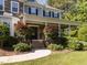 Inviting front porch with stone columns, manicured landscaping, and a curved walkway leading to the entrance at 1201 Kalworth Rd, Wake Forest, NC 27587