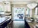 Open-concept kitchen and dining area with modern finishes, a stylish chandelier, and a view of the sunroom at 1201 Kalworth Rd, Wake Forest, NC 27587