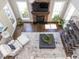 Open living room with stone fireplace, large windows, and comfortable seating with views from above at 1201 Kalworth Rd, Wake Forest, NC 27587