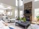 Bright living room with stone fireplace, large windows, tall ceilings, and comfortable seating at 1201 Kalworth Rd, Wake Forest, NC 27587