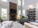 Spacious living room with a stone fireplace, large windows, and stylish decor and comfortable seating at 1201 Kalworth Rd, Wake Forest, NC 27587