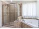 Elegant bathroom featuring a separate shower, a soaking tub, and tile flooring at 1201 Kalworth Rd, Wake Forest, NC 27587
