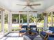 Bright sunroom featuring comfortable seating with backyard views and a ceiling fan to keep cool at 1201 Kalworth Rd, Wake Forest, NC 27587