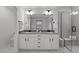 Stylish bathroom with double vanity, bright lighting, and modern glass shower at 125 Shadowdale Ln, Rolesville, NC 27571