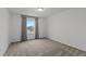 Bright bedroom featuring neutral carpet, light gray walls, and a window with matching gray curtains at 125 Shadowdale Ln, Rolesville, NC 27571