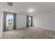 Bonus room with plush carpeting, natural light, and neutral decor offers flexible living space at 125 Shadowdale Ln, Rolesville, NC 27571