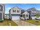 Attractive home with a welcoming front porch, manicured lawn, and a convenient attached garage at 125 Shadowdale Ln, Rolesville, NC 27571