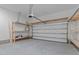 Spacious two car garage featuring built-in wooden shelving at 125 Shadowdale Ln, Rolesville, NC 27571