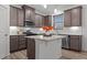 Modern kitchen featuring an island with pendant lights, stainless steel appliances, and tiled backsplash at 125 Shadowdale Ln, Rolesville, NC 27571
