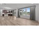 Bright living room with large windows, stylish curtains, and open access to the kitchen at 125 Shadowdale Ln, Rolesville, NC 27571