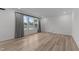 Spacious living room with large windows, neutral walls, and light wood-look flooring at 125 Shadowdale Ln, Rolesville, NC 27571