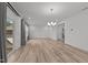 Open living space featuring a chandelier, sliding glass doors to the exterior, and light wood-look flooring at 125 Shadowdale Ln, Rolesville, NC 27571