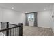 Comfortable loft space boasts plush carpeting and a large window with elegant gray curtains at 125 Shadowdale Ln, Rolesville, NC 27571