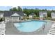 Community pool featuring lounge chairs and a pool house, surrounded by well-maintained landscaping and neighborhood homes at 125 Shadowdale Ln, Rolesville, NC 27571