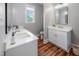 Well-lit bathroom featuring double vanities, quartz countertops, and modern fixtures at 129 E Chestnut Ave, Wake Forest, NC 27587
