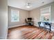 Bedroom with hardwood floors, natural light, and a ceiling fan at 129 E Chestnut Ave, Wake Forest, NC 27587