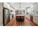Bright kitchen with stainless steel appliances, an island with seating, and an open layout to living spaces at 129 E Chestnut Ave, Wake Forest, NC 27587