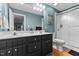 Bathroom featuring a double sink vanity, glass-enclosed shower, and hardwood floors at 14 Donnibrook, Fuquay Varina, NC 27526
