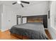 Bright bedroom featuring hardwood floors and a stylish accent wall at 14 Donnibrook, Fuquay Varina, NC 27526