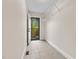 Hallway with ceramic tile flooring and access to the backyard through a glass-paneled door at 14 Donnibrook, Fuquay Varina, NC 27526