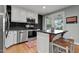 Well-equipped kitchen with an island, stainless steel appliances, and natural light at 14 Donnibrook, Fuquay Varina, NC 27526