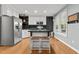 Charming kitchen with stainless steel appliances, a central island, and bright natural light at 14 Donnibrook, Fuquay Varina, NC 27526