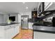 Well-lit kitchen showcasing stainless steel appliances and an eat-in kitchen island at 14 Donnibrook, Fuquay Varina, NC 27526
