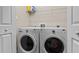 Functional laundry room with side-by-side washer and dryer and storage shelf at 14 Donnibrook, Fuquay Varina, NC 27526