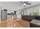 Open-concept living space with hardwood floors, seamlessly connects living and kitchen areas at 14 Donnibrook, Fuquay Varina, NC 27526