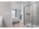 Ensuite bathroom featuring a tiled shower with glass door that leads into a bedroom at 1424 Rollman Farm Rd, Raleigh, NC 27603