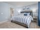 Charming bedroom with striped bedding, soft blue walls, and an ensuite bathroom for added convenience at 1424 Rollman Farm Rd, Raleigh, NC 27603
