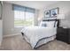 Bright bedroom with neutral walls, carpeted floors, and a window letting in natural light at 1424 Rollman Farm Rd, Raleigh, NC 27603