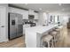 Bright kitchen showcasing white cabinets, stainless appliances, and a large island connecting to the open living area at 1424 Rollman Farm Rd, Raleigh, NC 27603