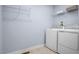 Practical laundry room with washer, dryer, and shelving for storage and organization at 1424 Rollman Farm Rd, Raleigh, NC 27603