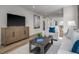 Cozy living room with wood floors, a neutral sofa, and a decorative coffee table at 1424 Rollman Farm Rd, Raleigh, NC 27603
