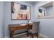 Comfortable office space with a wooden desk, a chair, and blue walls at 1424 Rollman Farm Rd, Raleigh, NC 27603