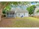 The home's backyard features a screened-in porch with an adjacent patio area and a beautiful blue chair at 149 Hutson Ln, Clayton, NC 27527