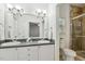 Bright bathroom boasts double sink vanity with countertop and glass door shower at 149 Hutson Ln, Clayton, NC 27527