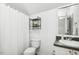 Bathroom with a vanity, toilet, and a shower-tub combo featuring tile surround at 149 Hutson Ln, Clayton, NC 27527
