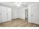 Bedroom features storage space, wood-look flooring, and a bright ceiling fan at 149 Hutson Ln, Clayton, NC 27527