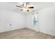 Cozy bedroom features a ceiling fan, white walls, and wood-look vinyl plank flooring at 149 Hutson Ln, Clayton, NC 27527