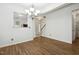 Dining area featuring wood flooring, a chandelier, and a view into the kitchen and foyer at 149 Hutson Ln, Clayton, NC 27527