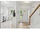 Bright foyer with tiled flooring, a staircase, and a view into the adjacent kitchen area at 149 Hutson Ln, Clayton, NC 27527