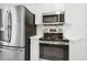 Modern kitchen with stainless steel appliances including a refrigerator, range, oven, and microwave at 149 Hutson Ln, Clayton, NC 27527